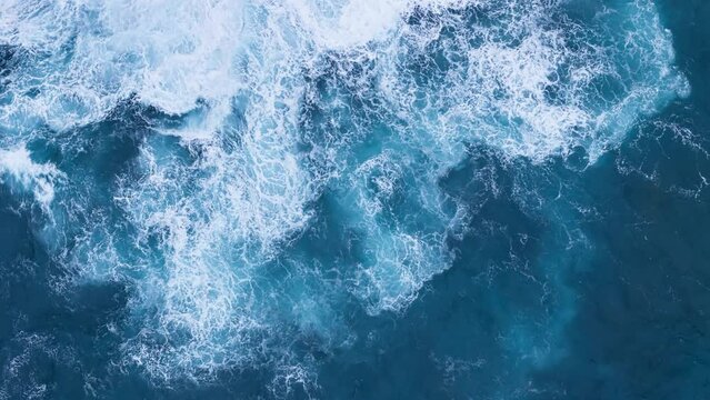 Big power ocean waves with white foam. Aerial top view footage of fabulous sea tide on a stormy day
