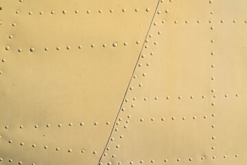 the texture of painted metal with rivets