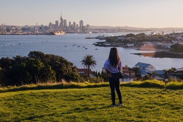 Woman on Northhead looking out to the city skyline in Devonport, Auckland, New Zealand.