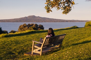 Park Bench on North head at sunset. Rangitoto Island is in the background. Devonport, Auckland, New...