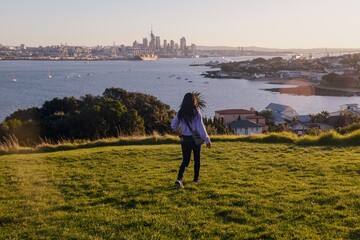 Woman on Northhead looking out to the city skyline in Devonport, Auckland, New Zealand.