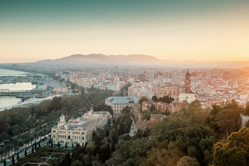 Obraz premium view over Malaga at sunset travel banner