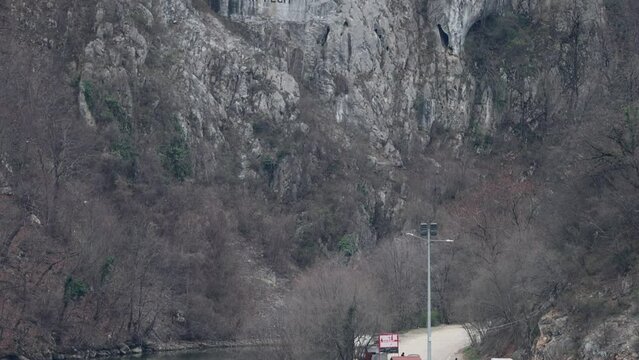 Rock Sculpture of Decebalus Last King of Dacia Colossal Face Carving in Stone at Danube River Gorge Tilt up Dubova Romania