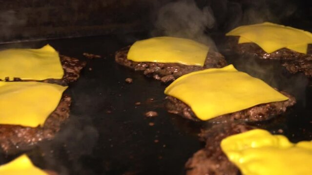 cooking smash hamburgers with cheese