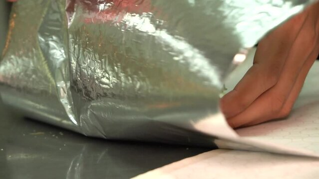 preparing food in the kitchen, wraping a doble cheeseburger