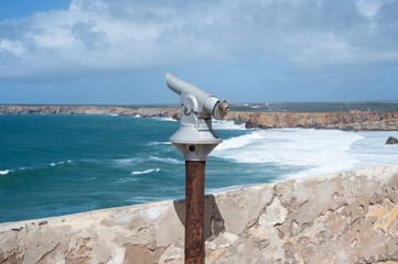 Sightseeing tourist coin operated telescope at watching point with scenic view in Algarve, Portugal