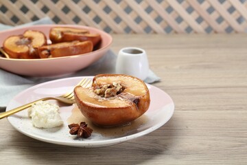 Delicious quince baked with honey and walnuts on wooden table