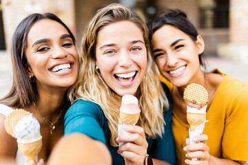 Portrait of happy multiracial women eating ice cream during summer vacation on Italy. Travel and...