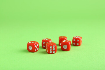 Many red game dices on green background