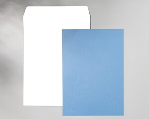 Blue paper, white envelope, flat lay design