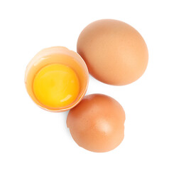 Whole and cracked chicken eggs isolated on white, top view