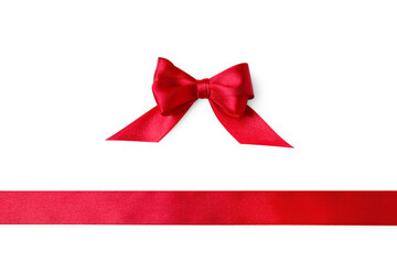 Red satin ribbon and bow on white background, top view