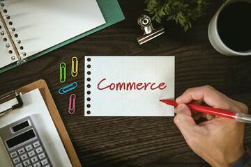 There is notebook with the word Commerce. It is as an eye-catching image.
