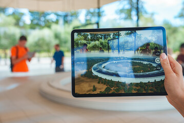 Person using iPad camera captures architectural view in Mountain View, California. Screen displays...