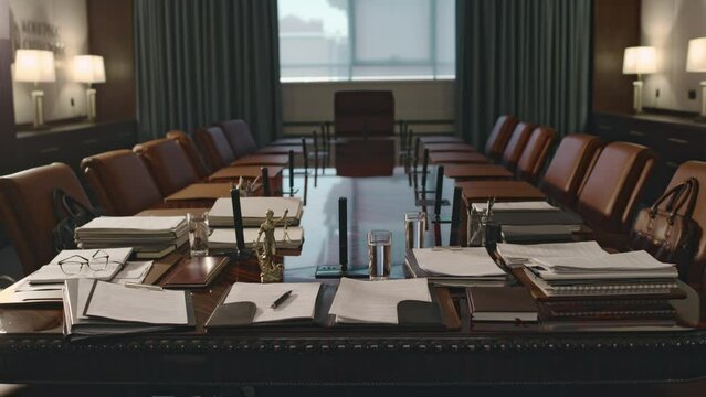 No people footage of large empty conference hall with lots of legal documents on wooden table at firm of attorneys