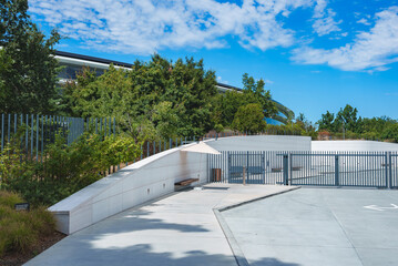Modern architectural structure at Apple complex, Mountain View, CA. Curved roofline in green...