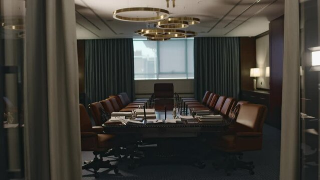 No people through doorway footage of empty luxurious conference hall with large wooden table, leather armchairs and chandelier in legal aid agency
