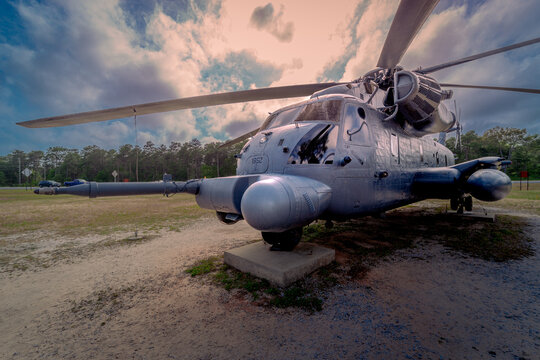 Eglin AFB, FL&mdash;April 29, 2024; sunsetting behind retired United States Air Force Sikorsky MH-53 Pavelow special operations helicopter on display at USAF armaments museum. 