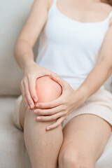 woman having knee ache and muscle pain due to Runners Knee or Patellofemoral Pain Syndrome,...