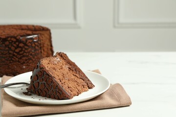 Piece of delicious chocolate truffle cake on white table, space for text