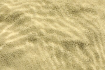 Sand under water as background, top view