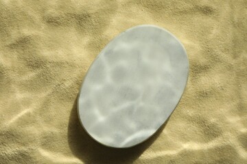 Obraz premium Stylish presentation for product. Stone podium on sand, top view