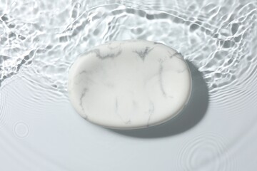 Presentation for product. Marble podium in water on white background, top view