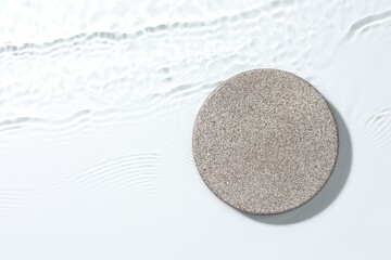 Presentation of product. Stone podium in water on white background, top view. Space for text