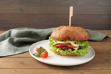 Delicious vegetarian burger served on wooden table