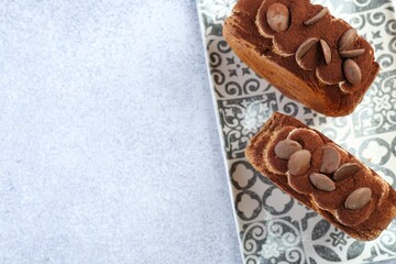 Tasty puff pastry. Supreme croissants with chocolate chips and cream on grey table, top view. Space for text