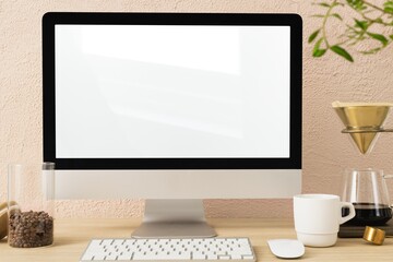 Minimal workspace, blank computer screen, coffee lover desk