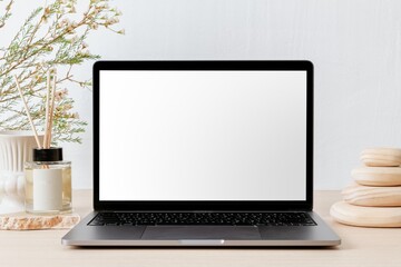 Fototapeta premium Aesthetic workspace with laptop and home aroma