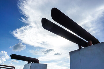 Ship exhaust pipes on a beautiful sky background