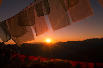 Hanging under sun against sky background and Sun rise over the valley in Bhutan