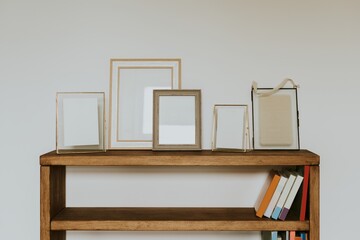 Empty frames on book shelf, natural home decor