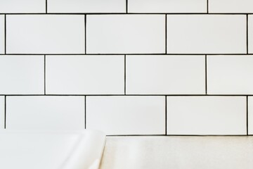 White tiled bathroom sink wall, product backdrop