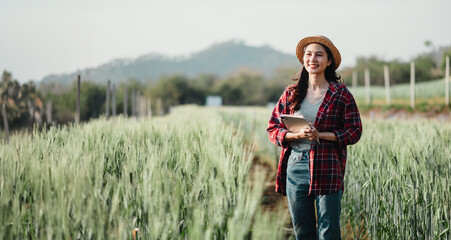 Content farmer stands in a sunny wheat field, holding a tablet for crop data analysis, exuding...