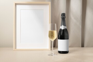 Blank picture frame, champagne bottle for celebration