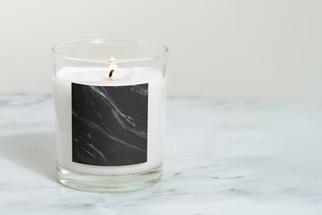 Lit candle on marble table