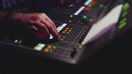 View of lighting technician operator working on mixing console workplace during live event concert on stage show broadcast, light mixer controller panel, sound technician with professional equipment
