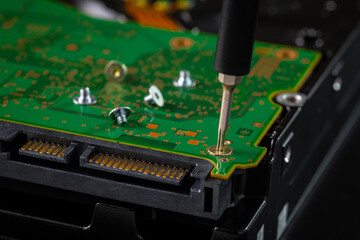 Hard disk drive and printed circuit board with SATA power connector. Magnetic driver torx bit and small machine screw