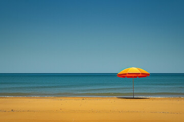 A vibrant beach umbrella casting a patch of shade on the golden sand, a welcome respite from the midday sun.