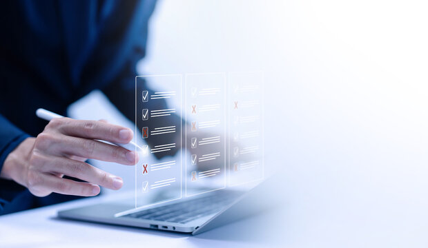 task audit in a list of documents, tick the checkmark in the survey item on a laptop. checklist concept, tick mark evaluation in options check form online, process order, detail business verify task