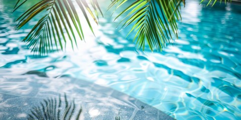 Fototapeta na wymiar Sunlit tropical palm leaves casting shadows over a clear blue swimming pool.