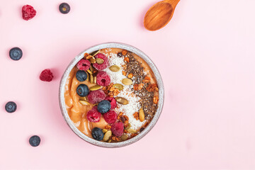 Breakfast smoothie bowl topped with berries and coconut flakes