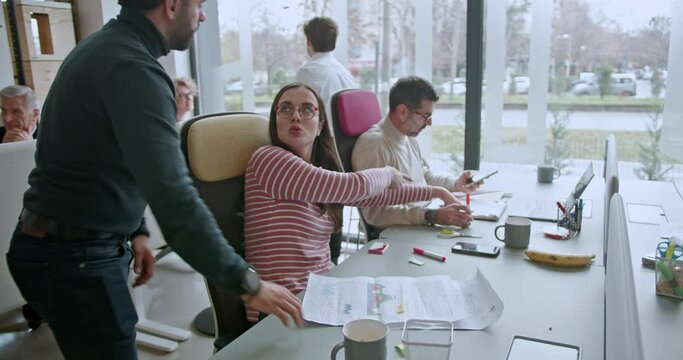 Multicultural group of multi generational business professionals brainstorming and strategizing for a successful future in a modern office setting.