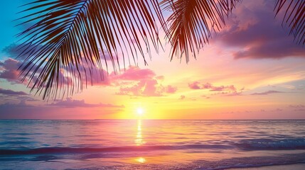 sunset over a serene beach with a palm tree and small wave in the foreground