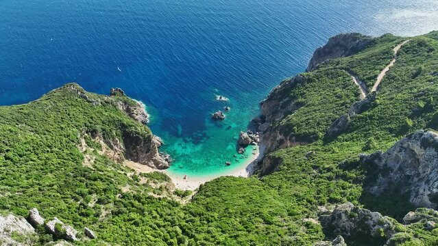 Giali beach in corfu, greece with turquoise waters and rugged cliffs, aerial view