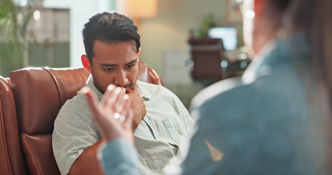 Therapy, sad and man talk with psychologist in office for mental health, anxiety or depression. Upset, grief and male person with emotions speak to healthcare worker for psychiatry advice in clinic.