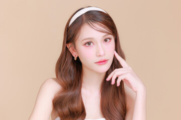 Pretty Asian beauty woman curly long hair with Korean makeup glowing face and healthy facial skin...